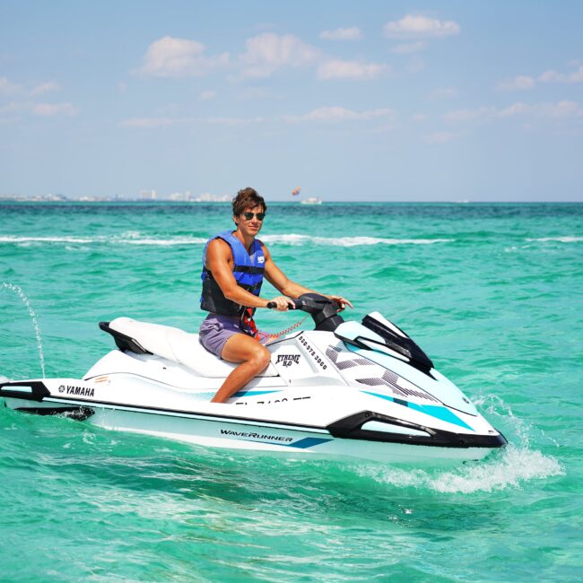 Person riding a jet ski on clear blue waters
