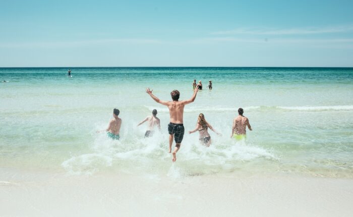 people running by the sea during their Destin family vacation