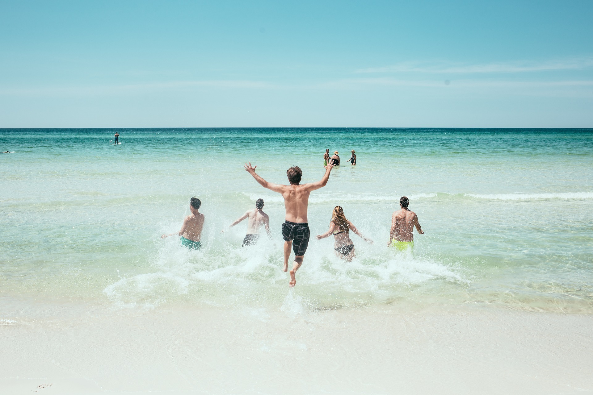 people running by the sea during their Destin family vacation