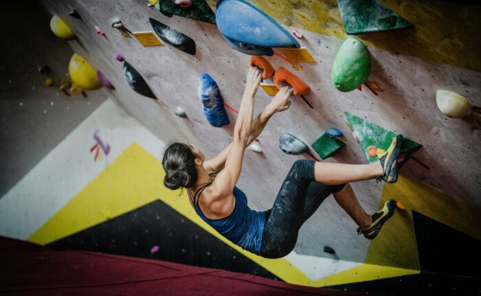 a woman climbing a rock wall