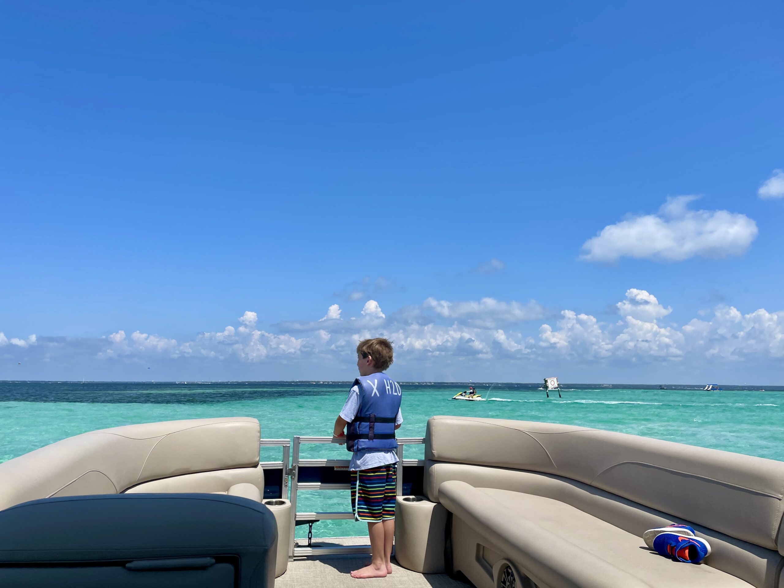 a boy standing on a boat