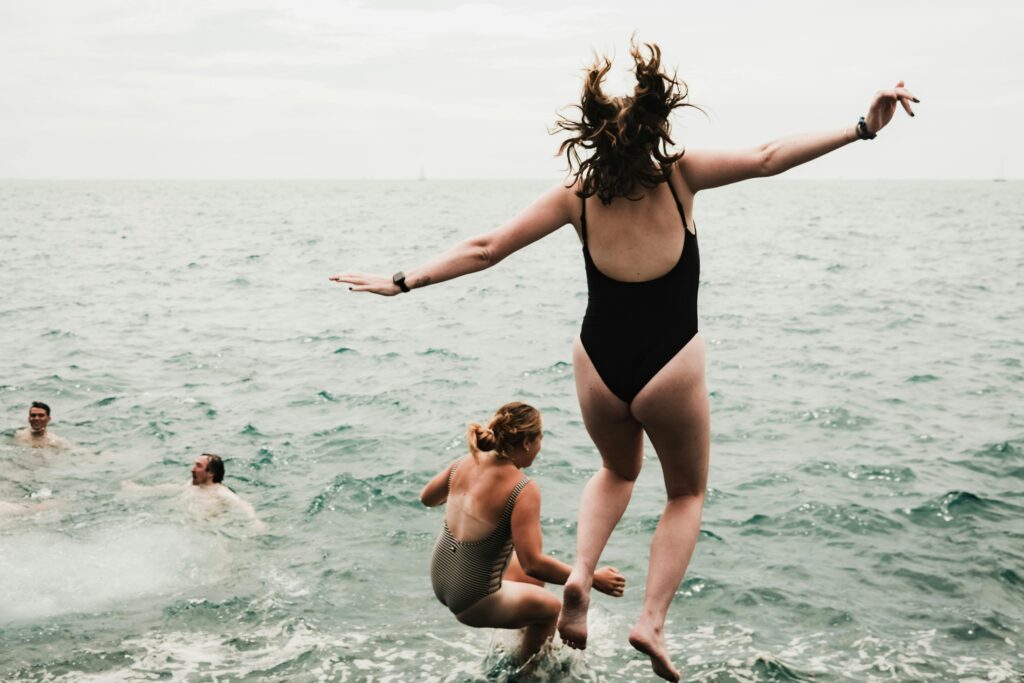 a woman jumping into the water