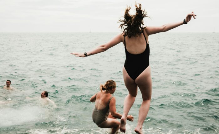 a woman jumping into the water